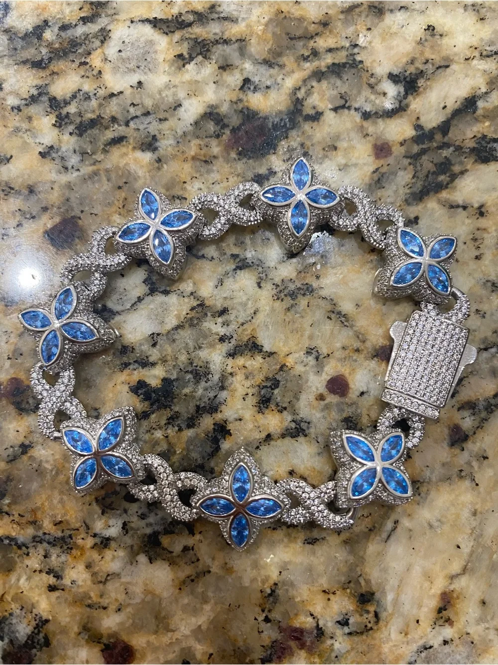 Sterling silver and moissanite floral bracelet with multi colored stones.
